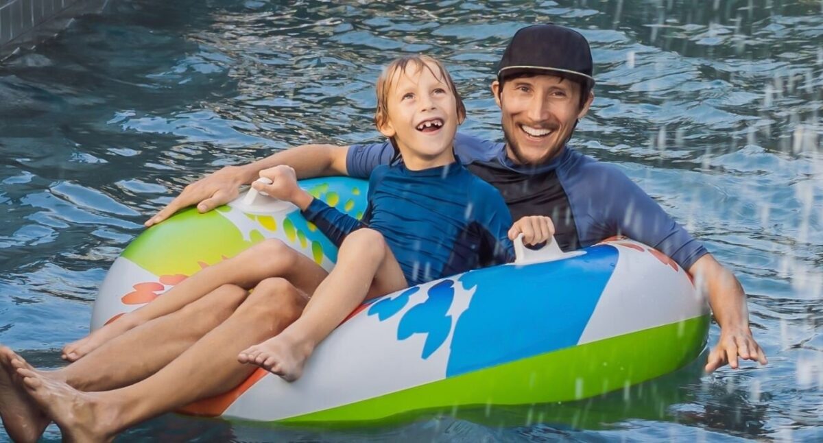father and son floating on tube