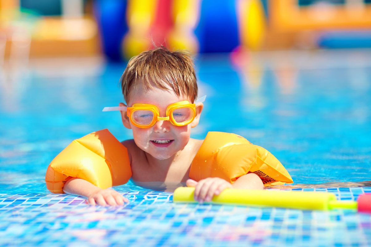 little boy in goggles at waterpark