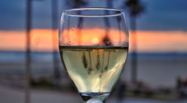 glass of wine in front of the sunset