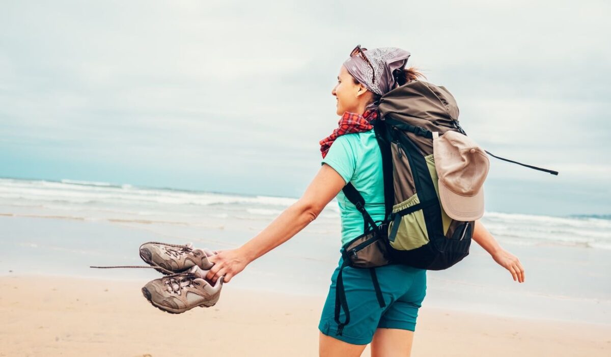 woman hiking on the beach