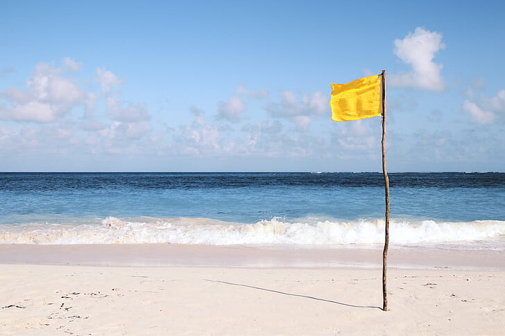 caution flag on the beach