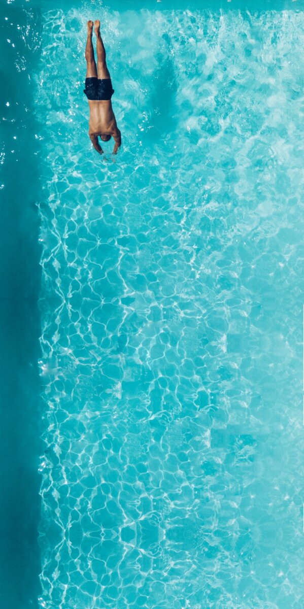 person diving into a pool