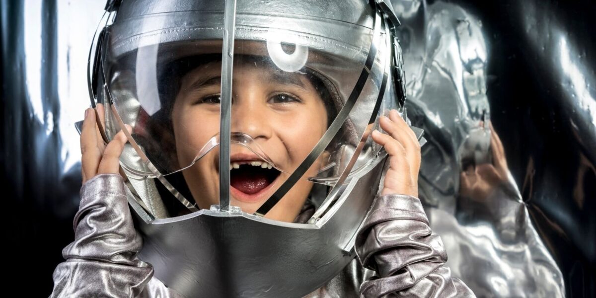 child in space suit laughing