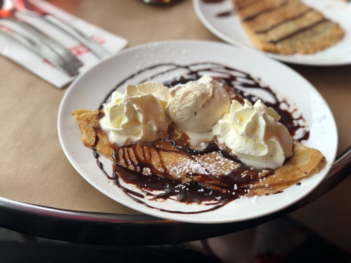 plate of crepes with chocolate and whipped cream