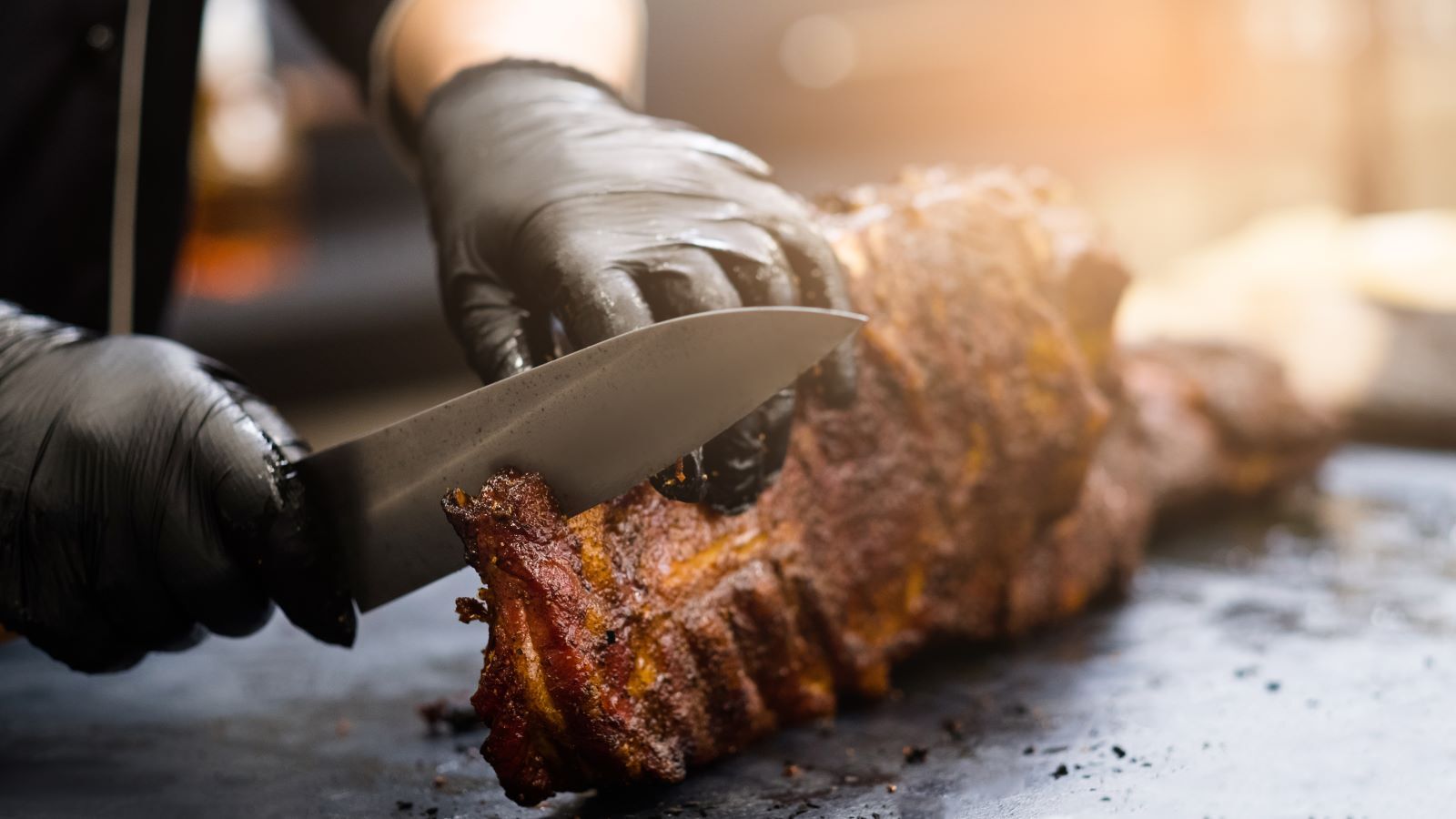 chef in BBQ restaurant cutting  up pork BBQ in restaurant 