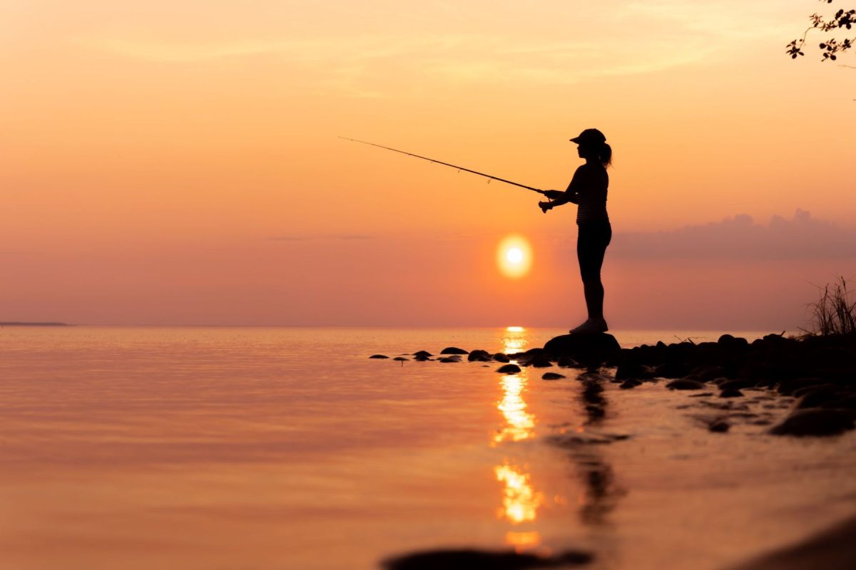 woman casting a line into the water